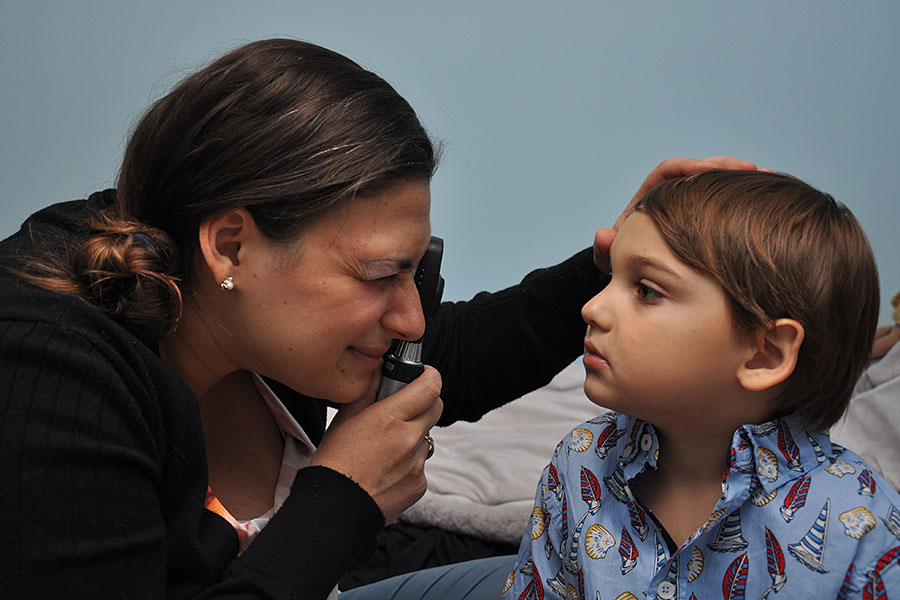 Dr Tsallas examining child